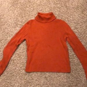 Orange turtleneck ribbed sweater